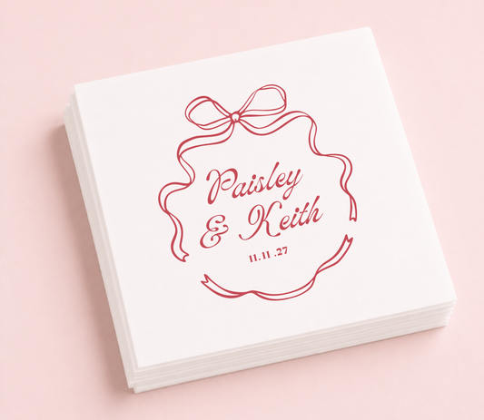 Personalized bow wedding cocktail napkins featuring a hand-drawn ribbon bow, custom couple names, and wedding date.