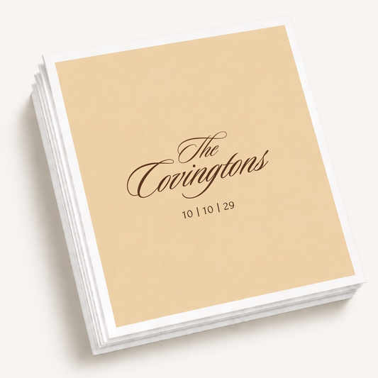 Personalized classic script wedding cocktail napkins featuring a custom family name and wedding date in an elegant minimalist design.