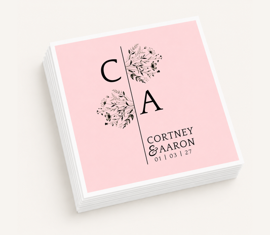Personalized split monogram wedding cocktail napkins featuring floral botanical accents, custom initials, couple's names, and wedding date.