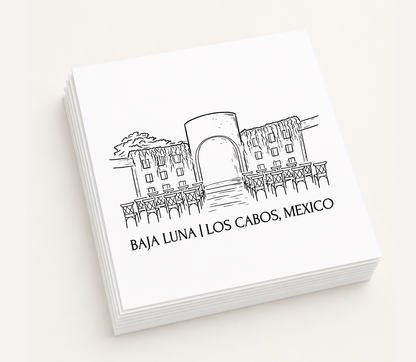 Personalized white cocktail napkins featuring a hand-drawn illustration of Baja Luna in Los Cabos, Mexico.