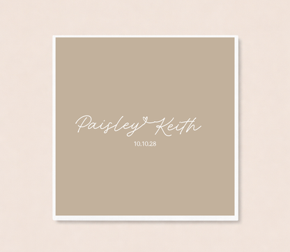 Personalized minimalist wedding cocktail napkins featuring handwritten couple names connected by a heart and custom wedding date.