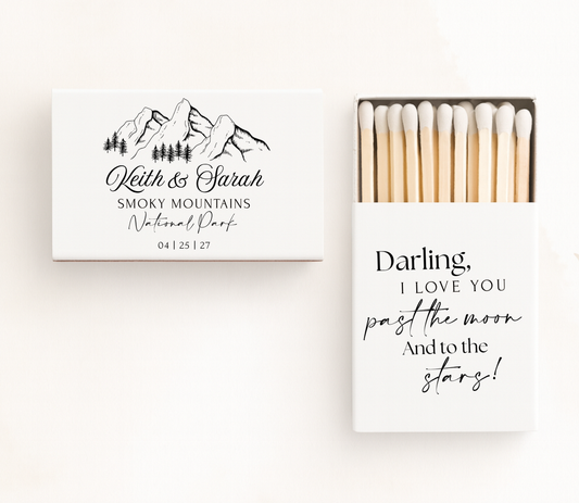 Personalized mountain wedding matchboxes featuring custom couple names, national park location, wedding date, mountain illustration, and romantic quote.
