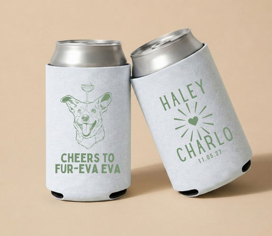 White personalized wedding can coolers featuring a custom dog portrait holding a cocktail, the phrase "Cheers To Fur-Eva Eva," and custom wedding names Haley and Charlo with wedding date 11.05.27.