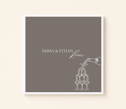 Personalized champagne tower wedding napkin featuring custom couple names and champagne pour illustration