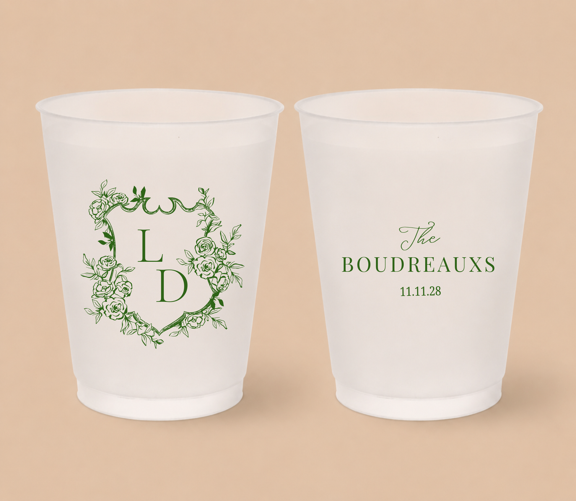 White frosted wedding cups featuring a floral crest with monogram initials LD, custom family surname The Boudreauxs, and wedding date.